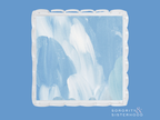 Square ceramic tray with blue and white abstract brush strokes and scalloped edges.