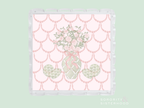 Clear acrylic tray with scalloped edges featuring a pink and green floral vase design on a pink scalloped background.