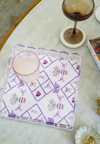 Clear acrylic tray with scalloped edges and purple geometric grapevine pattern.