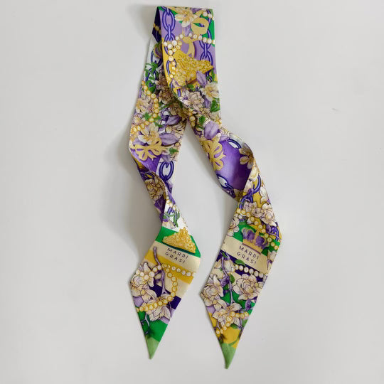 Purple Mardi Gras-themed scarflette with gold masks, beads, fleur-de-lis, and green accents.