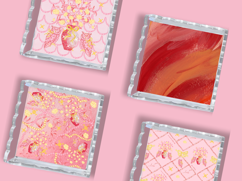 Four square acrylic trays with scalloped edges, featuring pink and red abstract and floral designs.
