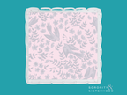 Pink acrylic tray with scalloped edges and light gray floral and bird pattern.