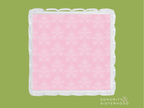 Square acrylic tray with scalloped edges and pink damask patterned center.
