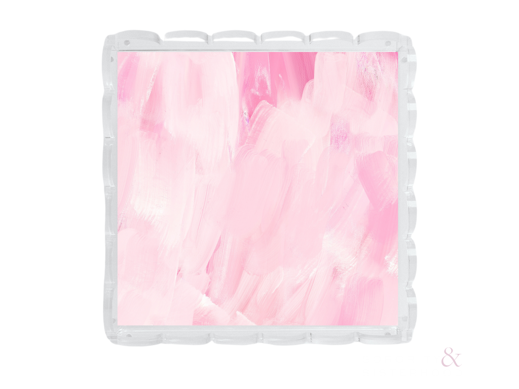 Square clear acrylic tray with scalloped edges and a pink and white abstract swirl design.