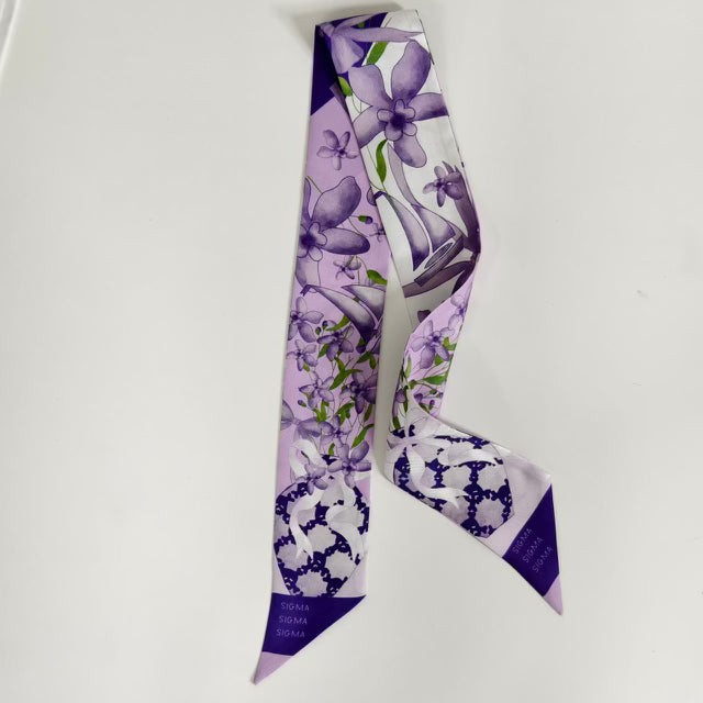 Purple and white floral patterned silk scarflette with Sigma Sigma Sigma details.