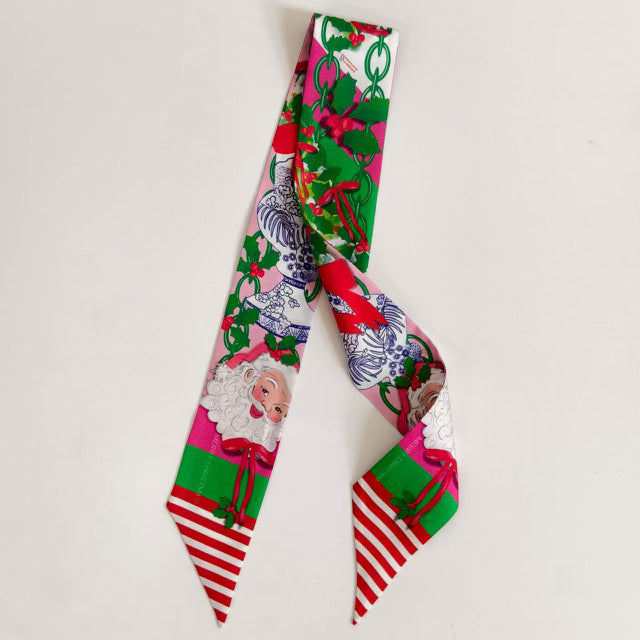Festive scarflette with Santa faces, green holly leaves, and red striped ends.