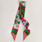Festive scarflette with Santa faces, green holly leaves, and red striped ends.