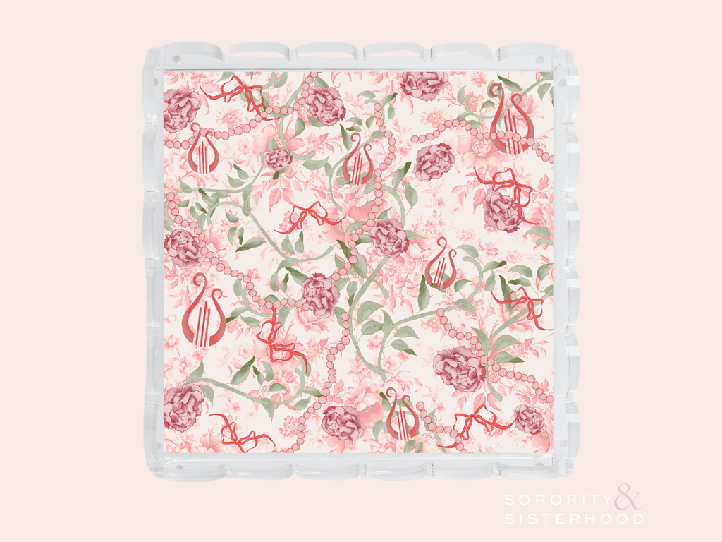 Acrylic tray with scalloped edges featuring a floral and Alpha Chi Omega symbol pattern in pink and green.