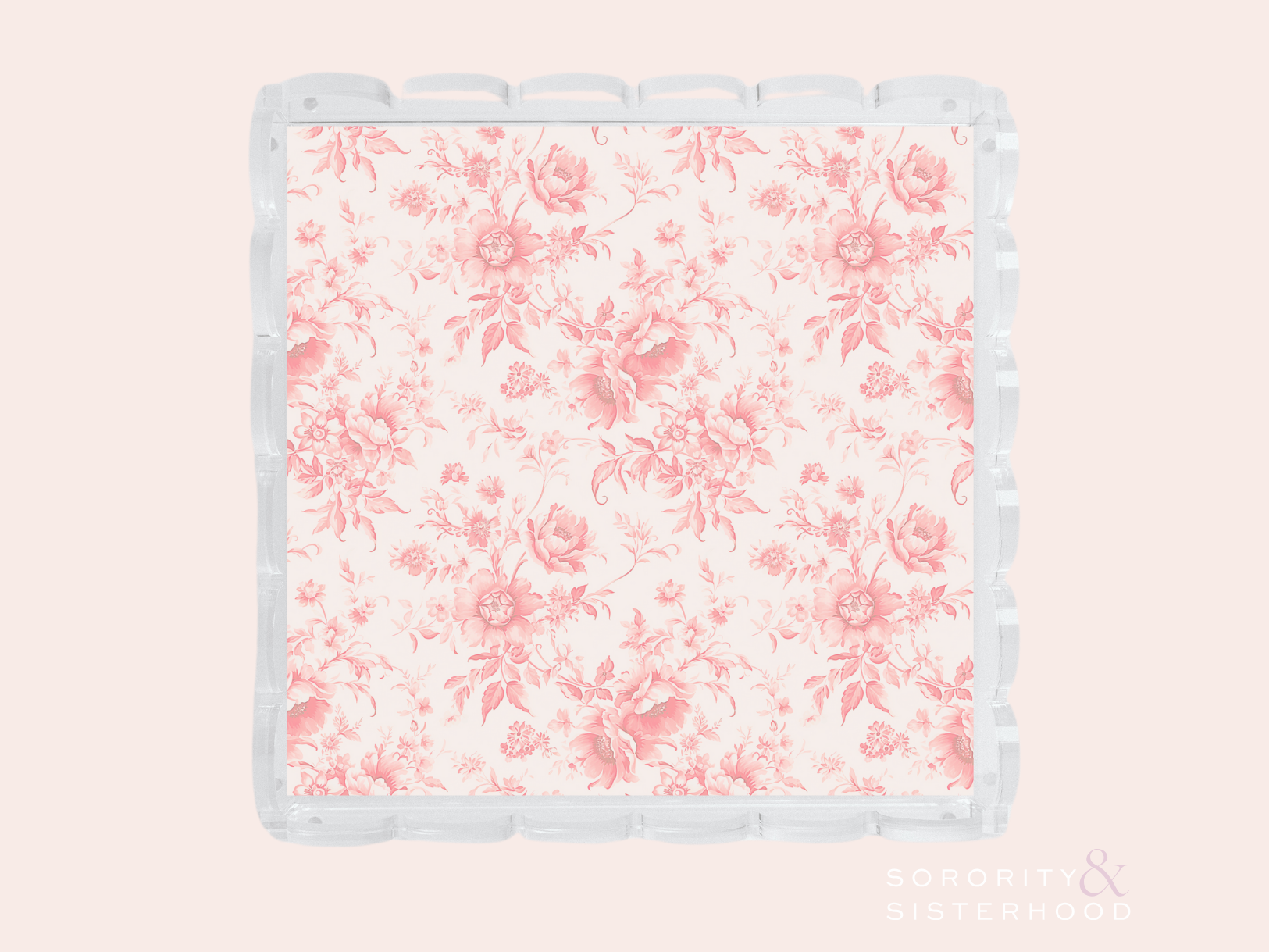 Clear acrylic tray with scalloped edges and pink floral pattern on base.
