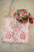 Clear acrylic tray with scalloped edges, pink floral and lyre designs, and a matching floral ribbon looped on top.