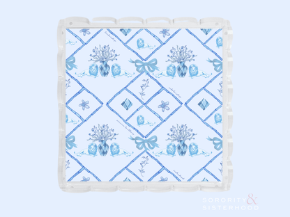 Square acrylic tray with scalloped edges and blue floral diamond pattern design.