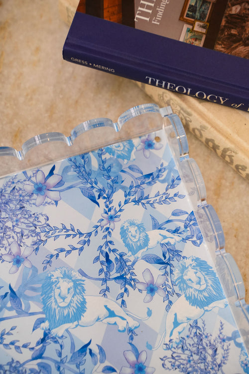 Clear acrylic tray with scalloped edges and blue floral and Alpha Delta Pi crest design on the base.