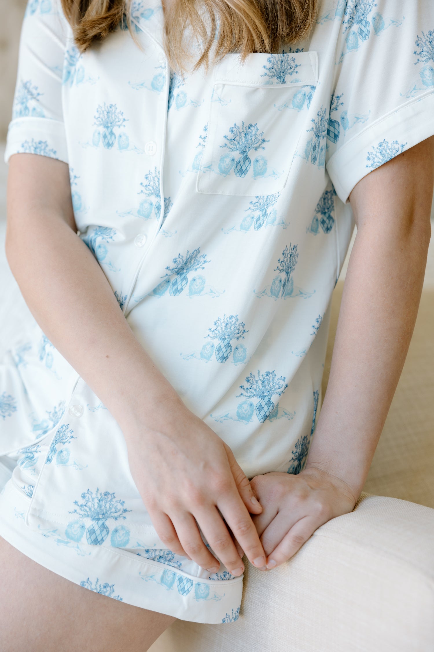 White pajama shorts set with light blue floral Alpha Delta Pi pattern and short sleeves.
