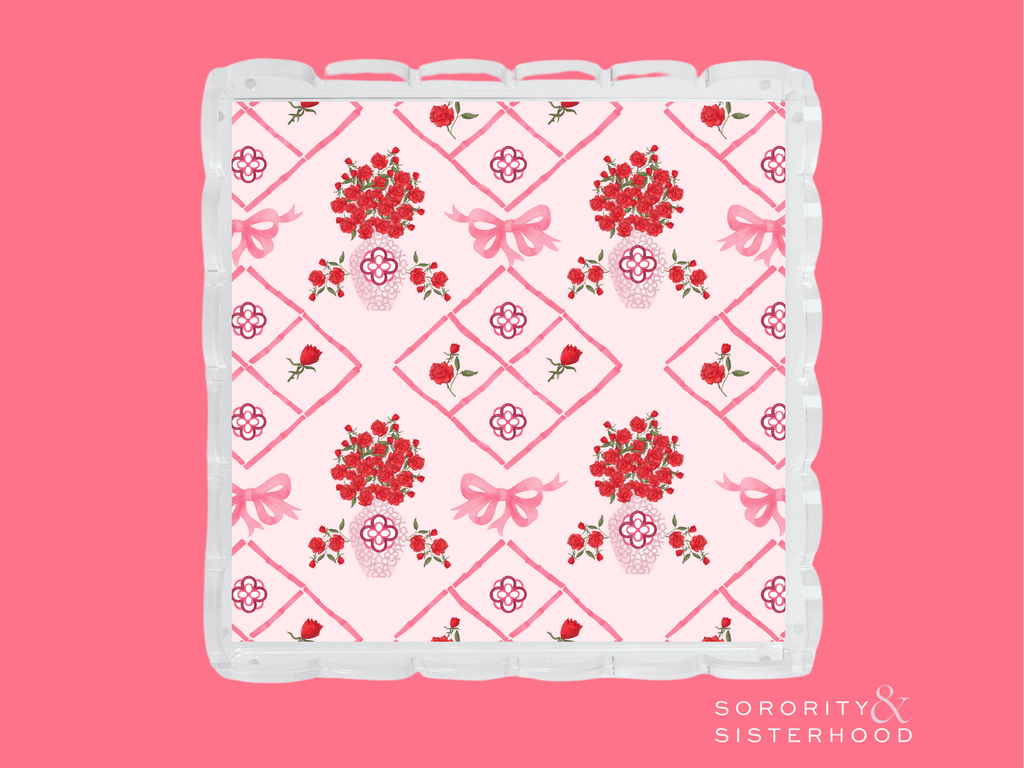 Pink and white acrylic tray with scalloped edges and red floral diamond pattern.