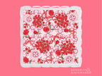 Acrylic tray with scalloped edges featuring red and pink floral and swirl patterns.