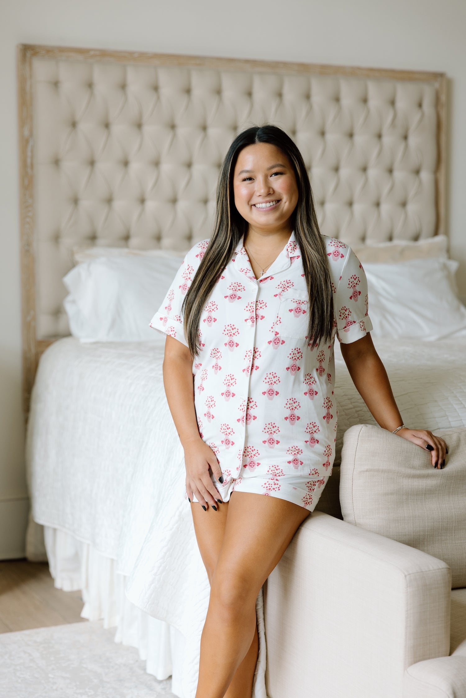 White pajama shorts set with pink floral Alpha Omicron Pi logo pattern and short sleeves.