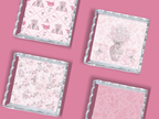 Set of four square acrylic trays with scalloped edges, each featuring pink and white patterns including alphabets, teddy.