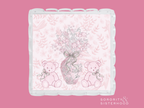 Clear acrylic tray with scalloped edges, pink floral background, and teddy bears holding a ribboned vase illustration.