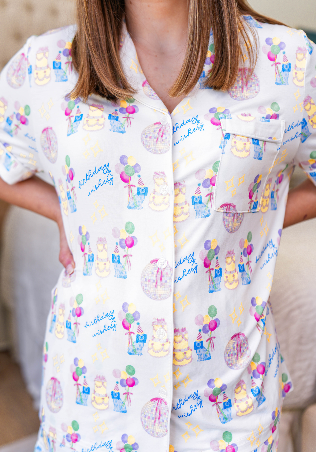 White button-up pajama top with colorful birthday-themed prints including cakes, balloons, and gifts.