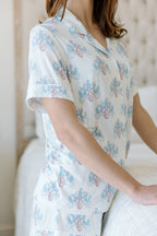 White short-sleeve pajama top with blue and pink floral print, relaxed fit.