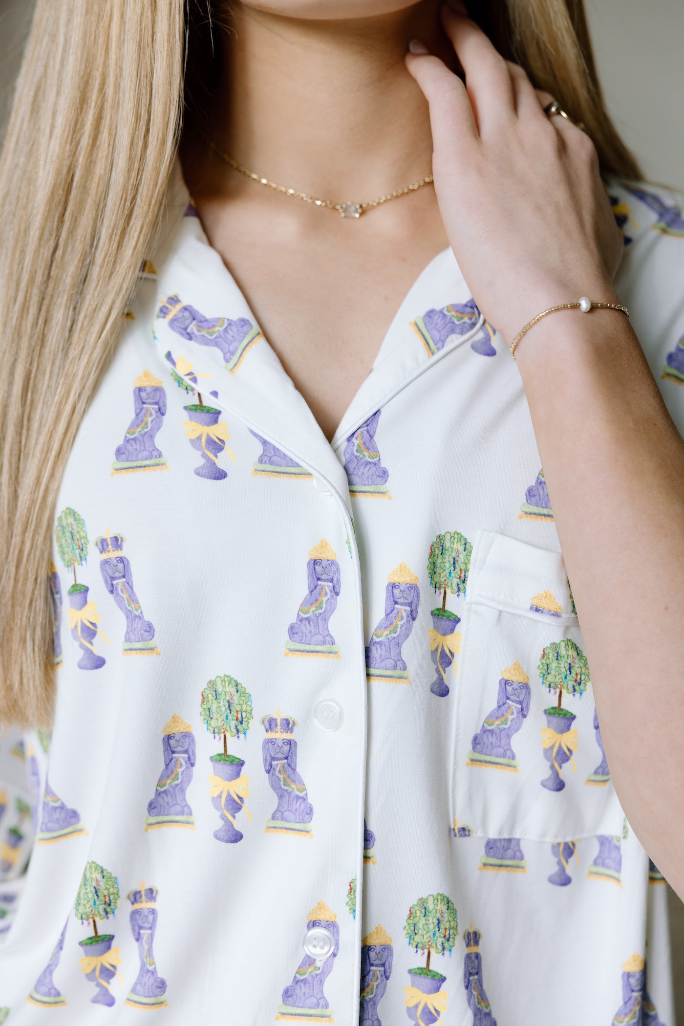 White pajama top with colorful Mardi Gras mask and bead prints, button-up style.