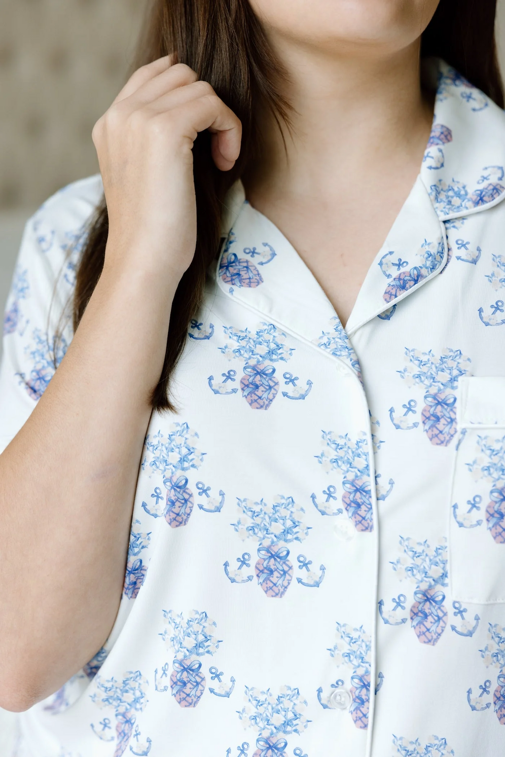 White pajama top with blue floral Delta Gamma pattern and notched collar.
